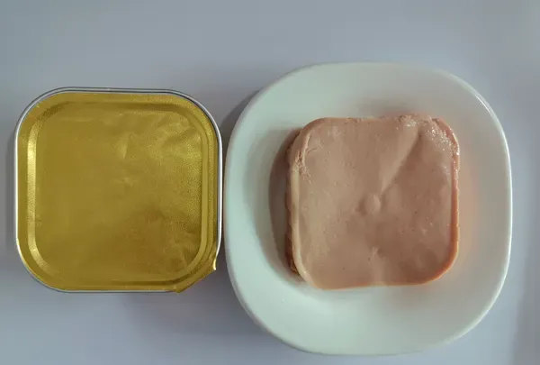 Aluminium tray of chicken pate pet food with the lid removed
