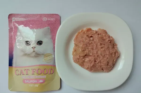 Tuna and salmon recipe cat food pouch with the contents plated