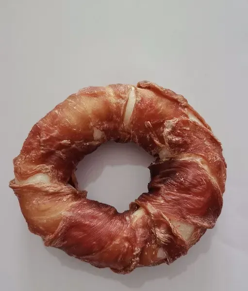 Ring-shaped duck donut dog treat with a darker meat wrap