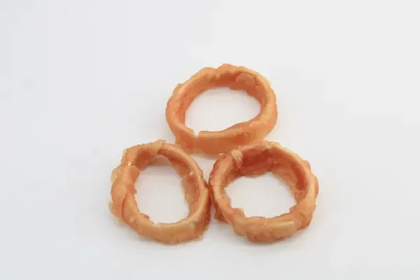 Three pale meat-wrapped rawhide rings stacked together
