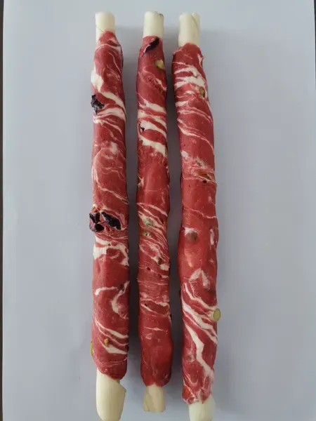 Long rawhide sticks spiral-wrapped with red meat strips