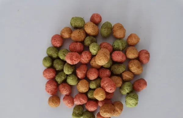 Colourful round dental crisp treats in green, orange and red