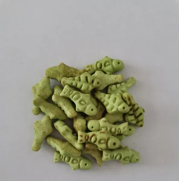 Green fish-shaped baked crisp treats with an embossed surface