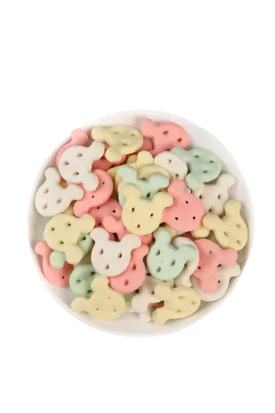 Mixed pastel bone and ring shaped pet biscuits in a dish