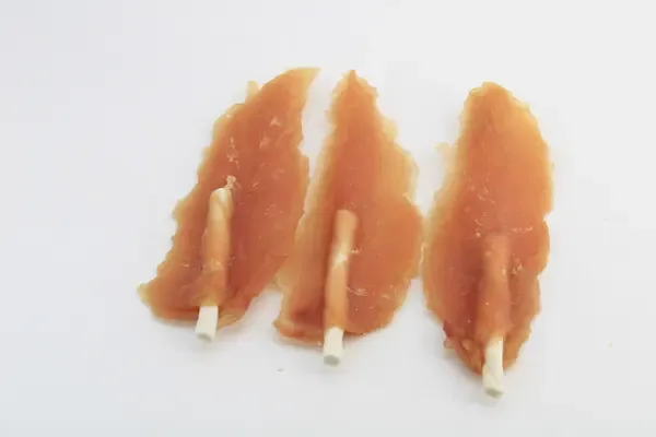 Three dried chicken breast fillets showing the natural grain of the muscle
