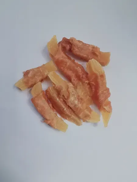 Dried chicken strips cut from breast meat, loosely arranged