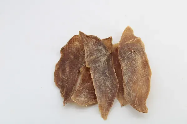 Two dark dried duck breast fillets with a dense, dried texture