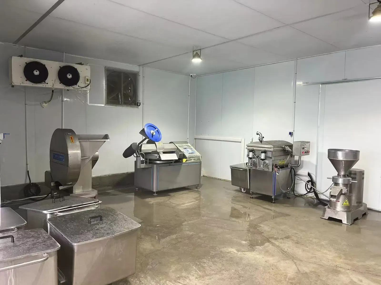 Meat preparation room with grinders and stainless steel work tables