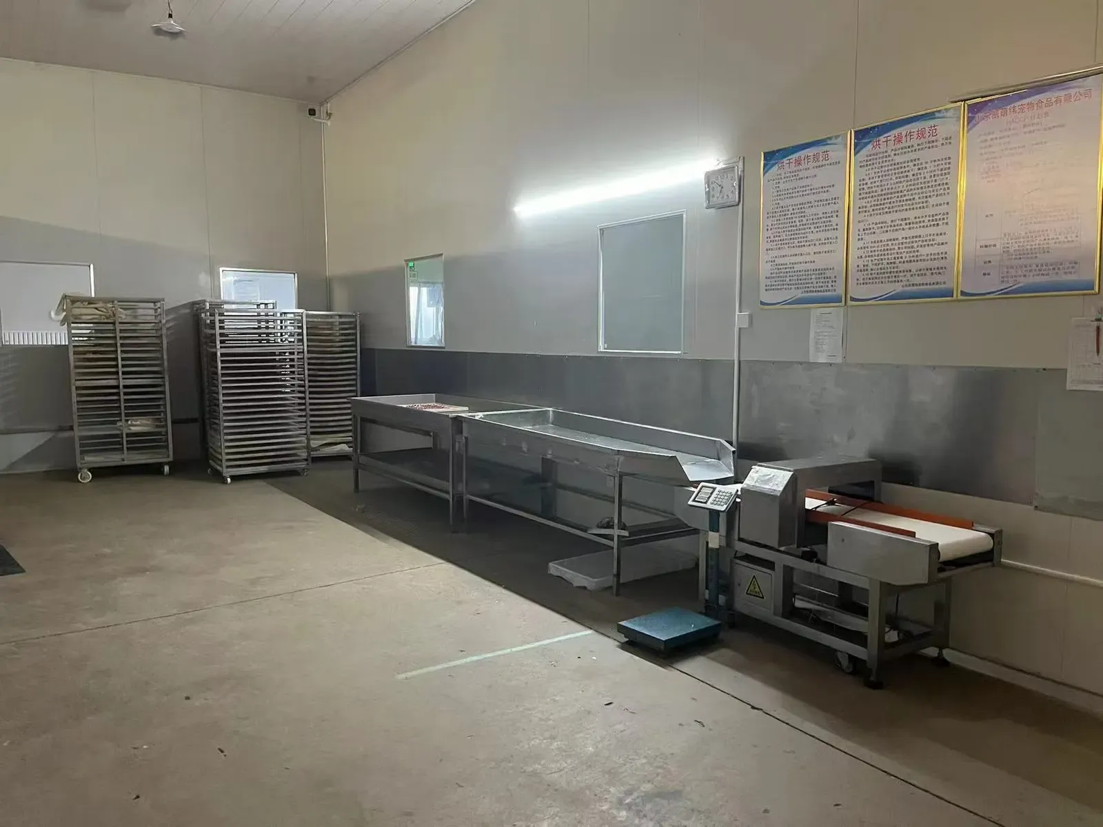 Stainless steel preparation room with trolleys and racking