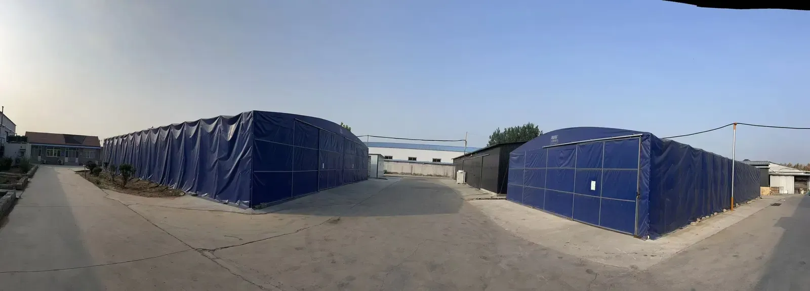 Blue-roofed production workshops seen across the factory site